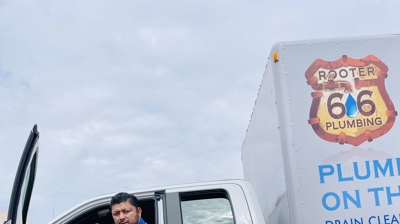 Plumber posing with the truck Photo